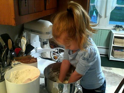 Violet loves helping Grandpa in the kitchen